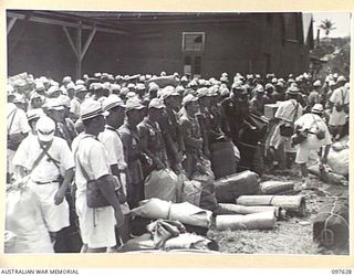 OCEAN ISLAND. 1945-10-02. JAPANESE PRISONERS LINED UP AT A CONCENTRATION POINT BEFORE BEING SEARCHED PRIOR TO EMBARKATION. FOLLOWING THE SURRENDER OF THE JAPANESE TROOPS OF 31/51 INFANTRY BATTALION ..