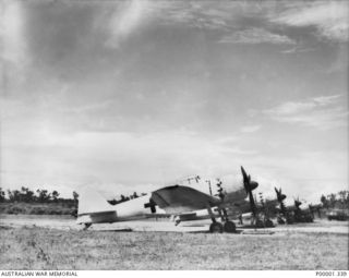 Four surrendered Japanese aircraft after arrival at the RNZAF airfield at Jacquinot Bay. The formation consisted of three Mitsubishi A6M5 Model 52 Zero fighters of the Imperial Japanese Navy ..