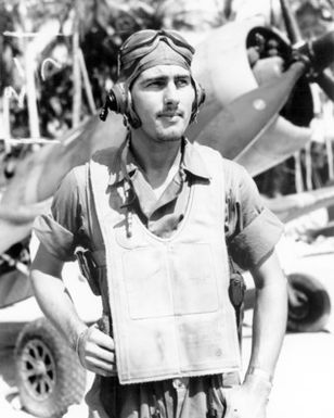 World War II (WWII) era photograph of US Marine Corps (USMC) Second Lieutenant (2LT) Alvin J. Jensen, standing in front of a US Navy (USN) F4U"CORSAIR"aircraft at Vella LaVella, Soloman Islands, November 14, 1943. 2LT Jensen is an Ace Pilot credited with 7 kills