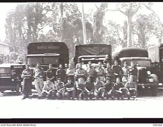 TOROKINA, BOUGAINVILLE, 1945-12-03. MEMBERS OF 1 DETACHMENT MOBILE CINEMA UNIT, WITH THEIR VEHICLES AT BOSLEY FIELD, WHICH WAS TAKEN OVER FROM THE AMERICANS AND IS THE LARGEST THEATRE AREA IN ..