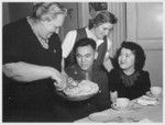 Time out for refreshments at a party for Nisei soldiers at the Nyack, N.Y., USO finds this serviceman and Nisei