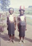 Highland styles in traditional head dress (men only) and wearing baler shell chest ornaments, on the right a "Tambul" man, 1963