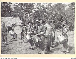 MOTUPENA POINT, BOUGAINVILLE, 1945-07-04. HIS ROYAL HIGHNESS, THE DUKE OF GLOUCESTER, GOVERNOR-GENERAL OF AUSTRALIA (1), INSPECTING THE BAND OF 29 INFANTRY BRIGADE DURING HIS VISIT TO THE AREA