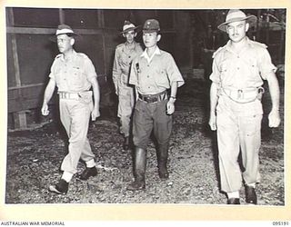 TOROKINA, BOUGAINVILLE, 1945-08-20. CAPTAIN TAKENAKA, ENVOY FROM LIEUTENANT-GENERAL M. KANDA, COMMANDER 17 JAPANESE ARMY GROUP, BEING ESCORTED TO A HUT AT HEADQUARTERS 2 CORPS FOR PRELIMINARY ..