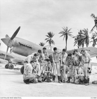 MOMOTE, LOS NEGROS ISLAND, ADMIRALTY ISLANDS, C. 1944-04. OFF ON A MISSION, THE PILOTS OF NO. 76 (KITTYHAWK) SQUADRON RAAF MAKE A QUICK TRIP OUT TO THE REVETMENTS AND THE COMMANDING OFFICER, ..
