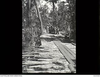 AITAPE, NORTH EAST NEW GUINEA. 1944-04-23. US TROOPS ON A CORDUROY TRACK THROUGH THE JUNGLE SHORTLY AFTER THE INVASION IN THE AITAPE AREA. THE TRACK IS CONSTRUCTED OF WOODEN POLES TIED TOEGETHER