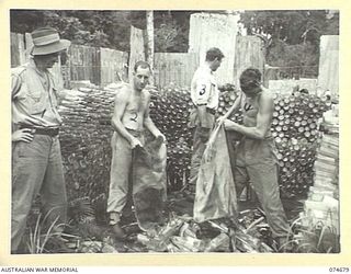 LAE-NADZAB, NEW GUINEA. 1944-07-25. PERSONNEL OF THE 8TH LINES OF COMMUNICATONS SALVAGE DEPOT CHECKING AND STACKING EMPTY BOTTLES AND JARS AT THE UNIT HEADQUARTERS. IDENTIFIED PERSONNEL:- VX127621 ..