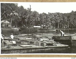 MOROBE, NEW GUINEA. 1943-08-15. TWO ROPES ARE BEING ATTACHED TO AS7 FOR A NIGHT TOW TO NASSAU BAY. IN ORDER TO MAINTAIN A CONTINUOUS SERVICE FREE FROM JAPANESE INTERFERENCE, THE FULL BARGES ARE ..