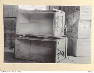 TOROKINA, BOUGAINVILLE, 1945-06-21. ARMY PACKING CASES AT THE DETAIL NEW GUINEA SUB DEPOT, LHQ DENTAL STORES, HQ 4 BASE SUB AREA. THE BOTTOM CASE IS A STANDARD DENTAL PACKING CASE; THE TOP CASE IS ..