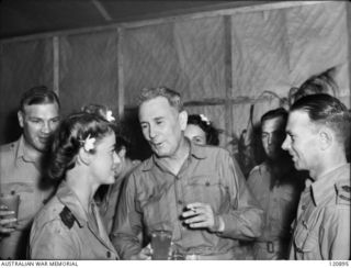 RABAUL, NEW BRITAIN. 1945-12-28. THE PRIME MINISTER OF AUSTRALIA, MR BEN CHIFLEY, ARRIVED BY PLANE TO VISIT MANY OF THE UNITS IN THE AREA. MR CHIFLEY TALKING TO A SISTER OF THE 118TH AUSTRALIAN ..