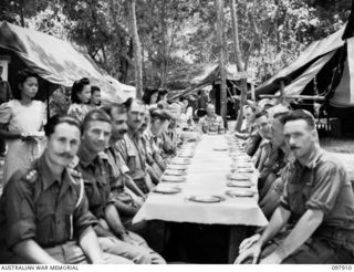 RABAUL, NEW BRITAIN. 1945-10-10. MAJOR GENERAL K.W. EATHER, GENERAL OFFICER COMMANDING 11 DIVISION, AND PARTY, ATTENDING THE OFFICIAL DINNER HELD IN THE OPEN AT THE CHINESE ARMY CAMP. A SPECIAL ..