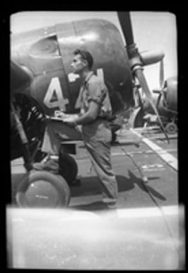 [Serviceman with General Motors FM-2 Wildcat aircraft]