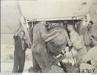 VIVIGANI, GOODENOUGH ISLAND, PAPUA. 1943-11-17. ARMOURERS LOADING A 2000LB DAISY-CUTTER BOMB INTO A BEAUFORT BOMBER AIRCRAFT OF NO. 8 SQUADRON RAAF IN READINESS FOR THE HEAVY ALL-AUSTRALIAN ..