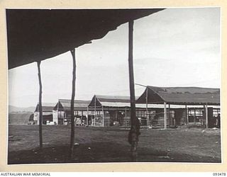 WEWAK AREA, NEW GUINEA. 1945-06-28. SHEDS CONSTRUCTED BY AUSTRALIAN NEW GUINEA ADMINISTRATIVE UNIT NATIVES AT THE FIELD MAINTENANCE CENTRE, ASSISTANT DIRECTOR OF ORDNANCE SERVICE DUMP, HEADQUARTERS ..