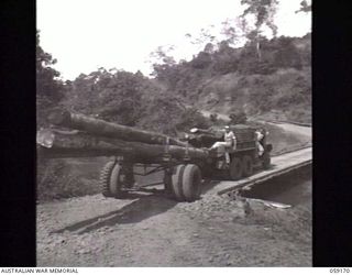 SOGERI VALLEY, NEW GUINEA. 1943-11-05. AN AMERICAN TIMBER JINKER HAVING DIFFICULTY NEGOTIATING A NARROW BRIDGE OVER THE EWARIGO CREEK. THIS TRUCK IS ONE OF THE MANY USED TO TRANSPORT LOGS AND ..