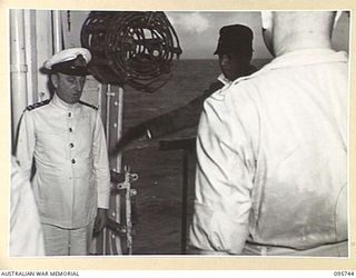 AT SEA OFF RABAUL, NEW BRITAIN. 1945-09-06. GENERAL H. IMAMURA, COMMANDER EIGHTH AREA ARMY SALUTES AS HE COMES ABOARD THE AIRCRAFT CARRIER HMS GLORY FOR THE SIGNING OF THE SURRENDER OF ALL JAPANESE ..