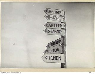 WUNUNG PLANTATION, JACQUINOT BAY, NEW BRITAIN. 1945-03-02. A MUCH DECORATED SIGNPOST IN THE GROUNDS OF THE 105TH CASUALTY CLEARING STATION