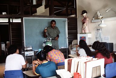 Hospital Corpsman 1ST Class Curtis K.A. Phillip teaches nursing students how to use an oxygen tank during a Civic Action Team-sponsored class at Yap Memorial Hospital. The team, comprised of United States Navy construction battalion members, is deployed to Yap to offer vocational training as well as to aid villagers with construction projects