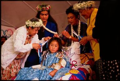 Lai Teiva snips a lock of Kayne Lucas Upokokeu's hair, at hair-cutting ceremony, Mangere Auckland