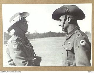 STRATHPINE, QUEENSLAND, AUSTRALIA. 1944-07-20. NX136489 PRIVATE T.B. WALTON (1) OF THE 2/25TH INFANTRY BATTALION, RECEIVING THE MILITARY MEDAL RIBBON FROM QX6305 MAJOR T.J.C. O'BRYEN, ..