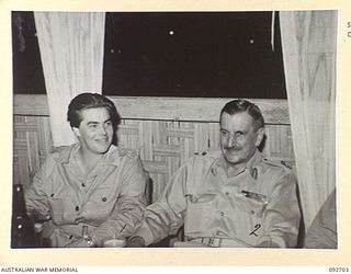 LAE AREA, NEW GUINEA. 1945-06-02. CAPTAIN M.W. HORNSBY, COMMANDANT AUSTRALIAN WOMEN'S ARMY SERVICE LINES, NEW GUINEA (1), AND MAJOR GENERAL B.M. MORRIS, GENERAL OFFICER COMMANDING ANGAU (2), AT A ..