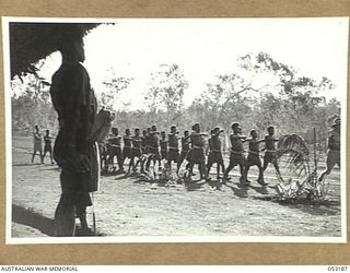 BISIATABU, NEW GUINEA. 1943-07-01. PLATOON OF TRAINING COMPANY, 1ST PAPUAN INFANTRY BATTALION MARCHING PAST THE ORDERLY ROOM