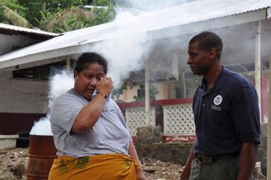 Earthquake ^ Flooding ^ Tsunami - Fagatogo, American Samoa, October 20, 2009 -- Tsunami survivor Rose of Sharon wipes tears as she recalls the death of a loved one in her home beside Pago Pago Harbor, which was destroyed by the tsunami on Sept. 29. FEMA Federal Coordinating Officer Kenneth R. Tingman, listens and offers his condolences. Richard O'Reilly/FEMA