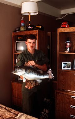SRA Bruce Tilley displays a fishing trophy