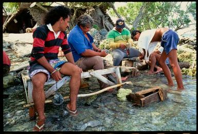 Men making chaplets of oyster shells, Manihiki, Cook Islands