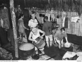 KUMUIA YAMA, RABAUL AREA, NEW BRITAIN. 1945-09-17. THE COOKHOUSE AT THE CHINESE INTERNMENT CAMP. THE MEN ARE PART OF A COMPLETE UNIT WHO WERE BROUGHT BY THE JAPANESE TO WORK IN NEW BRITAIN DURING ..