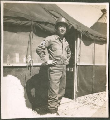 Soldier in front of tents