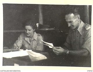 BOUGAINVILLE ISLAND. 1945-01-29. VX38 MAJOR M.B. DUNCAN, REGISTRAR, 21ST AUSTRALIAN GENERAL HOSPITAL, DICTATING A LETTER TO WFX34327 SERGEANT E.M. HAWKES AUSTRALIAN ARMY MEDICAL WOMEN'S SERVICE, IN ..