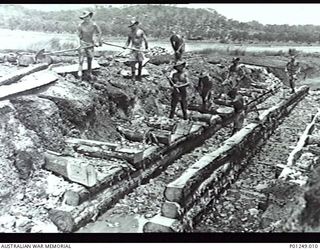 WARDS STRIP, PORT MORESBY, NEW GUINEA, 1943-03. FOUR MEMBERS OF THE RAAF CUT A LOG ON A CIRCULAR SAW. WARDS AERODROME WAS WORKED ON BY BOTH NO. 2 AND NO. 5 MOBILE WORKS SQUADRON (LATER AIRFIELD ..