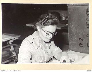 LAE, NEW GUINEA, 1945-05-23. LANCE-CORPORAL M.E. REILLY, PROVISION CLERK, NO 2 SUB DEPOT, 4 ADVANCED ORDNANCE DEPOT. AWAS PERSONNEL ARE AT LAE TO RELEASE MEN OF HQ FIRST ARMY FOR DUTY IN FORWARD ..