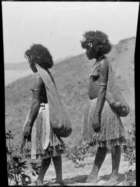 Two women wearing grass skirts and bilums, Papua, ca. 1923 / Sarah Chinnery