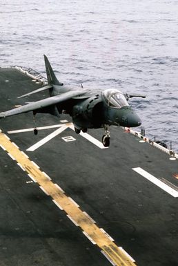 An AV-8B Harrier aircraft attached to Marine Medium Helicopter Squadron 261 (HMM-261) comes in for a landing on the flight deck of the amphibious assault ship USS SAIPAN (LHA-2) during a rehearsal for Operation Sharp Edge. The SAIPAN is on station off the coast of Liberia