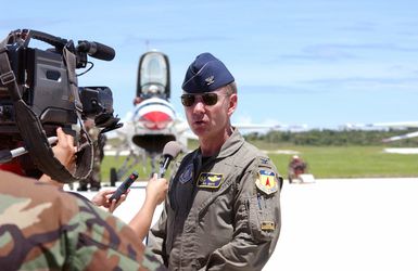 U.S. Air Force COL. P. K. White, Commander, 36th Air Expeditionary Wing, is interviewed by members of the local media upon the arrival of the U.S. Air Force Thunderbirds Aerial Demonstration Team, at Andersen Air Force Base, Guam, September 9, 2004. This landing marks the first time in a decade the Thunderbirds Demonstration Team has visited Guam. The Thunderbirds will be performing during an air show held Sunday, September 12, 2004. (U.S. Air Force PHOTO by AIRMAN 1ST Class Kristin Ruleau) (Released)