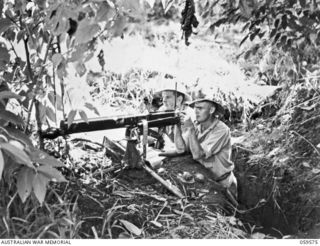 FINSCHHAFEN AREA, NEW GUINEA, 1943-10-28. NX55479 CORPORAL S. WATSON OF SCONE, NSW (1) (LEFT), AND NX29660 CORPORAL A.E. BROWN OF WOLLONGONG, NSW (2), BOTH OF THE 2/2ND AUSTRALIAN MACHINE GUN ..