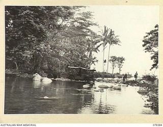 WIDE BAY AREA, NEW BRITAIN. 1945-01-16. AN AMBULANCE JEEP OF THE 14/32ND INFANTRY BATTALION CROSSING THE PAPKE RIVER BETWEEN SAMPUN AND KALAMPUN