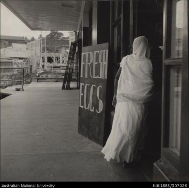 Woman standing in shop doorway