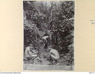 KIARIVU, NEW GUINEA, 1945-08-09. PERSONNEL OF C COMPANY, 2/7 INFANTRY BATTALION WASHING THEMSELVES AND THEIR CLOTHES. IT WAS THEIR FIRST WASH FOR DAYS. THE TROOPS CARRIED ONLY ONE SET OF CLOTHES. ..