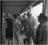 Tourists on board a navy ship or a tour boat off Pearl Harbor, Hawaii, 1930s