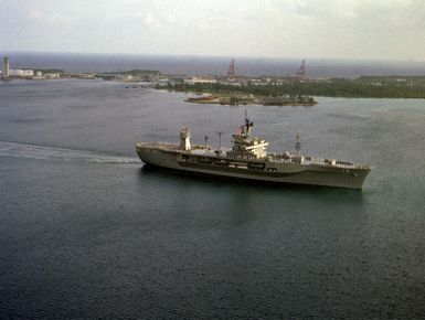 An elevated starboard view of the amphibious command ship USS BLUE RIDGE (LCC 19) entering the harbor