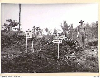 SWAN BEACH, JACQUINOT BAY. NEW BRITAIN. 1944-12-10. PRIVATE T.R. FULWOOD, 250 SUPPLY DEPOT PLATOON, AUSTRALIAN ARMY SERVICE CORPS, IN THE 2 FIELD AMBULANCE, AUSTRALIAN ARMY MEDICAL CORPS AREA ..