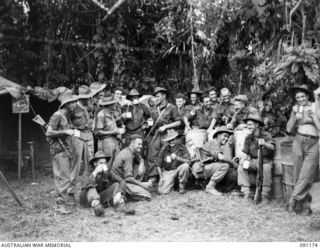 KARAWOP AREA, NEW GUINEA. 1945-04-19. CORPORAL K.W. LINDUS (4), IN CHARGE OF THE Y.M.C.A. STALL. CALLED KEITH'S CAFE, IT SERVES HOT AND COLD DRINKS TO TROOPS. 2/1 INFANTRY BATTALION AND OTHER 6 ..