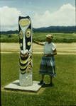 Kathleen Vellacott-Jones standing next to a Sepik ancestor figure, at Wewak, New Guinea