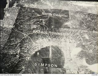 VIVIGANI, GOODENOUGH ISLAND, PAPUA. C. 1943-12-21. SPIDER OVER RABAUL. THIS PHOTO MOSAIC OF RABAUL WAS INVADED BY A SPIDER, WHICH MAY BE SYMBOLIC OF THE JAPANESE HOLD ON THE BASE