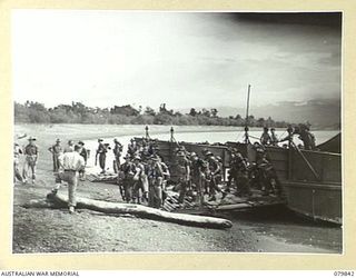 KALAI PLANTATION, NEW BRITAIN. 1945-03-15. TROOPS OF THE 16TH INFANTRY BATTALION, 13TH INFANTRY BRIGADE, ARRIVING BY AUSTRALIAN LANDING CRAFT. IDENTIFIED PERSONNEL ARE:- WX30094 PRIVATE C.H. BATT ..