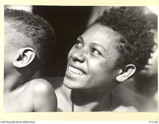 ALEXISHAFEN, NEW GUINEA. 1944-05-11. KEMAS, A SAIR ISLAND NATIVE WOMAN, THE WIFE OF BOOKA (OR BUKA) A MANUS ISLAND NATIVE. THE COUPLE WERE MARRIED AT THE AMERICAN MISSION, MADANG, IN 1935. DURING ..