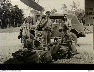 Goodenough Island, New Guinea. 1943. Members of a RAAF Beaufighter squadron unloading mail for Australian troops. From the left they are, Flight Lieutenant M. Burrows of Williamstown, Victoria, ..